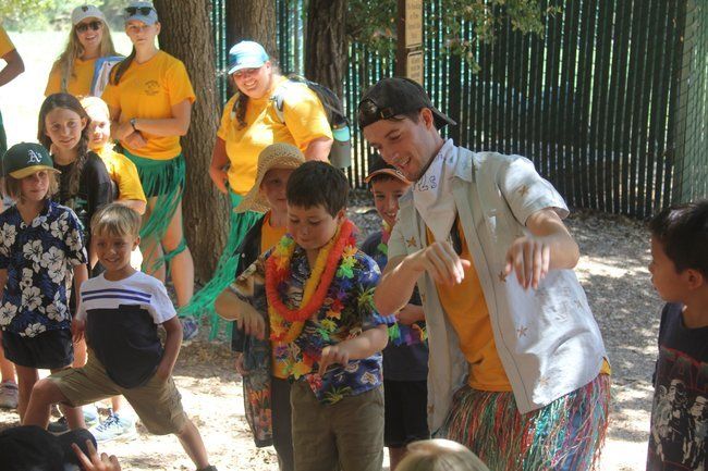 Counselor and campers celebrating Hawaiian dress up day, hula dancing. Counselor and campers celebrating Hawaiian dress up day, hula dancing.